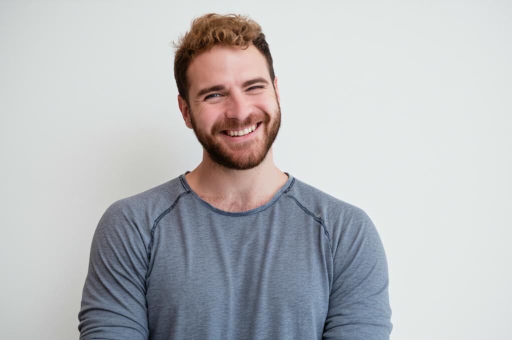 Man smiling confidently, perhaps looking at his partner with affection. Positive and energetic mood.